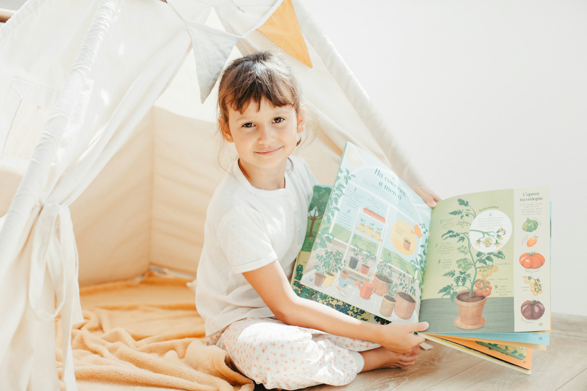 Preschooler child reading book at home